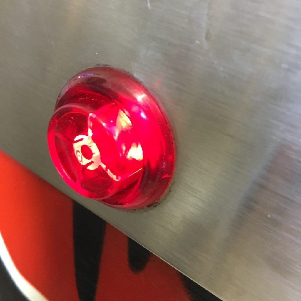 Red incandescent flipper button